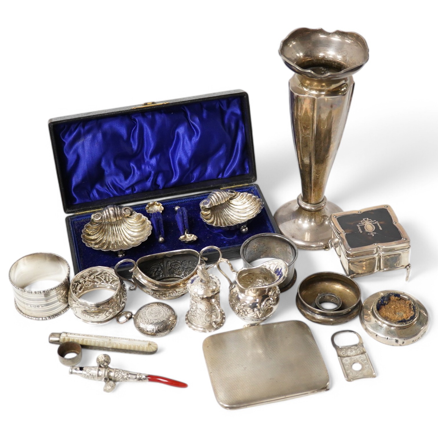 A collection of mainly small silver items including a George V posy vase, mother of pearl handled fruit knife, sovereign case, cream jug, tortoiseshell and silver trinket box (a.f.), continental miniature white metal tan